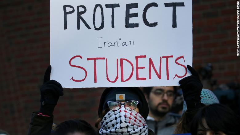 BOSTON, MA - JANUARY 21: Cassidy Taylor offers support to a deported Iranian student while protesting outside the federal courthouse in Boston, MA on January 21, 2019. An Iranian student planning to attend Northeastern University was removed from the country overnight Monday in defiance of a court order, his lawyer said, and a federal judge said Tuesday there was nothing that he could immediately do. Mohammad Shahab Dehghani Hossein Abadi, 24, had been detained by Customs and Border Protection at Logan International Airport since arriving in the US on Sunday. Hossein Abadi???s lawyers filed an emergency petition to block his removal Monday night, and Judge Allison D. Burroughs ordered a 48-hour stay. (Photo by Craig F. Walker/The Boston Globe via Getty Images)