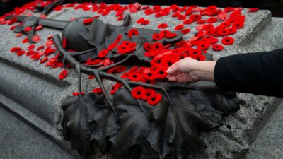 A person places their poppy on the Tomb of the Unknown Soldier following the a Remembrance Day ceremony at the National War Memorial, Thursday, November 11, 2021 in Ottawa. THE CANADIAN PRESS/Adrian Wyld